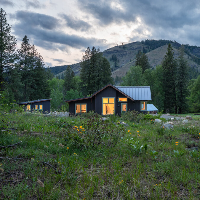 A home in a rural mountain setting at dusk